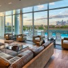 sky lounge with city views and windows looking out at rooftop pool